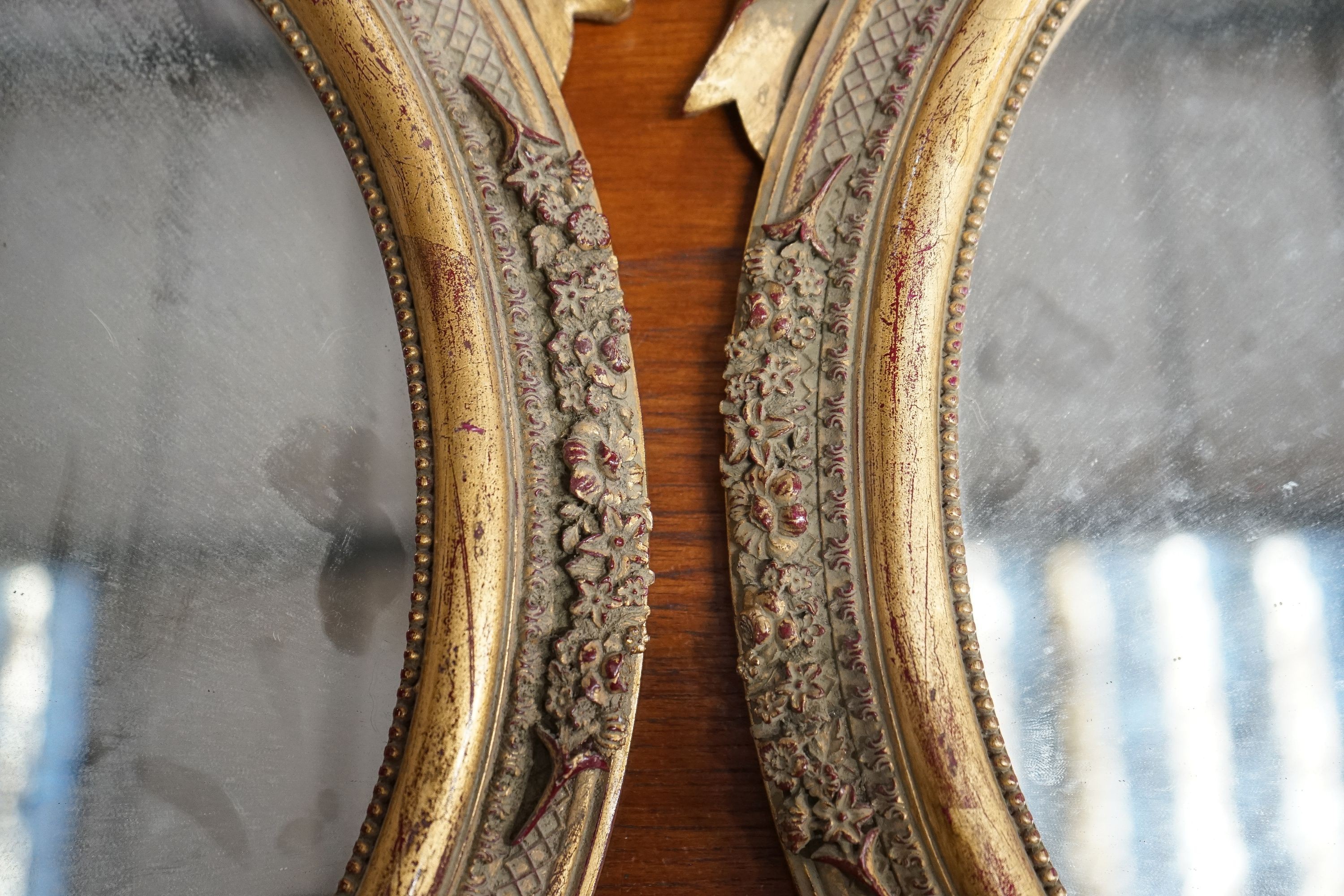 A pair of Victorian style oval gilt framed wall mirrors, width 37cm, height 52cm